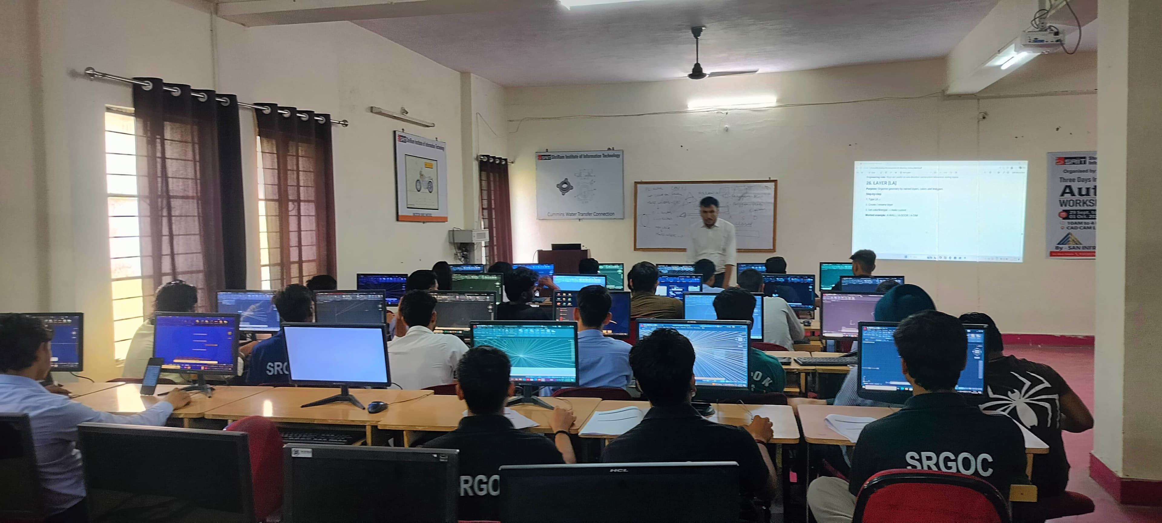 Students practising AutoCAD at computers during a previous SAN workshop